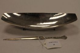 A silver shallow dish with hammered fininsh, together with a silver letter opener. (2) CONDITION