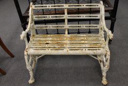A Victorian cast iron garden seat, decorated with dog head terminal arms, width 94 cm. CONDITION