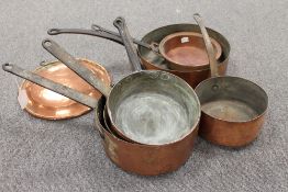 Seven French copper pans and a copper plate. (8) CONDITION REPORT: Good time aged condition, with