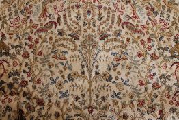A Kashmir fringed rug with flora and fau