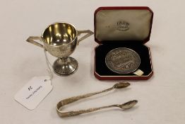 A small silver presentation cup, together with a pair of silver sugar nips and a City and Guilds