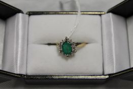 A 9ct gold emerald and diamond cluster r