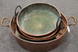 Four French copper twin-handled pans. (4) CONDITION REPORT: Good time aged condition.