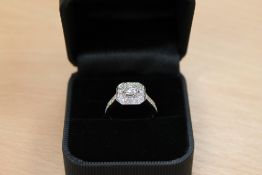 An 18ct white gold diamond cluster ring, approximately 1.1ct, colour G, with diamond shoulders.