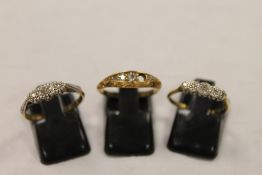 Three 18ct gold diamond set rings. (3) CONDITION REPORT: One ring missing a stone, the other two