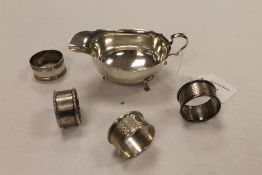 A silver sauce boat, Birmingham 1921, together with four silver napkin rings. (5) CONDITION