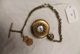 A Swiss gilt metal pocket watch, on white metal chain with 9ct gold fob. CONDITION REPORT: The watch