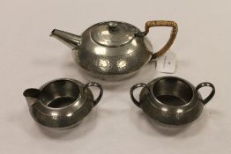A three piece Tudric pewter tea service. (3) CONDITION REPORT: Good condition, the base numbered