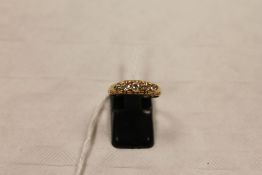 An 18ct gold five stone diamond ring. CONDITION REPORT: Old cut stones with some visible inclusions,