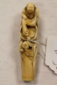 A carved Chinese ivory depicting a lady washing cloth, length 11 cm. CONDITION REPORT: Good