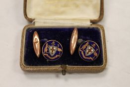 A pair of 9ct gold and enamel cuff links, cased. CONDITION REPORT: Fair condition, small knock to