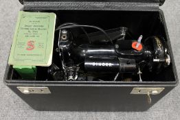 A Singer portable sewing machine model 221K, in original case with accessory kit. CONDITION
