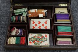 A Victorian brass inlaid games box with ivory chips, together with another similar box with