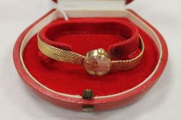 A 9ct gold lady's Omega wrist watch, 20.4g. CONDITION REPORT: Good condition, with original red
