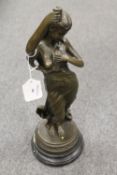 A bronze study of a lady holding a dove,