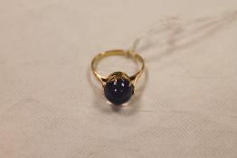 A 14ct gold cabochon ring. CONDITION REPORT: The blue stone unknown, thought to be a sapphire.