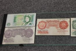 Seven bank notes - Ten shillings and One pounds, framed under glass. CONDITION REPORT: Good