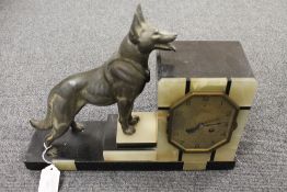 A French Art Deco onyx and marble clock, mounted with a metal dog, width 40 cm. CONDITION REPORT: