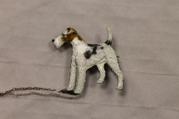 A sterling silver and enamel brooch modelled as a fox terrier, width 3.5 cm. CONDITION REPORT: