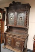 A late Victorian carved oak hunting cabi