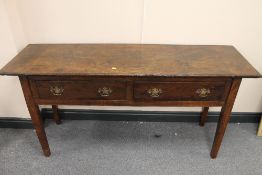 An early nineteenth century two drawer side table, on square tapered legs, width 154 cm. CONDITION