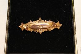 A 9ct gold diamond set brooch.