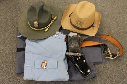 An original Georgia State patrol uniform, with two hats and holster. CONDITION REPORT: Good