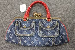 A Louis Vuitton denim and red leather hand bag. CONDITION REPORT: Good condition, barely used.