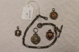 An early twentieth century silver watch chain, together with four silver fobs. (5) CONDITION REPORT: