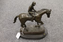 A bronze study of a horse and jockey wit