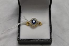 An 18ct gold diamond and sapphire cluste