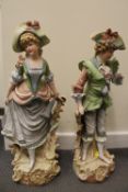 A pair of late nineteenth / early twentieth century continental bisque figures in period costume,