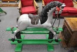 A painted wooden rocking horse, height 105 cm. CONDITION REPORT: Probably early twentieth century,