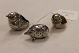 A silver novelty pin cushion depicting a hedghog, together with two others depicting birds. (3)