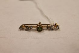 An Edwardian peridot and diamond set bar brooch. CONDITION REPORT: Width 38mm, condition good, the