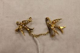 A pair of 15ct gold seed pearl swallow brooches, 2.9g. CONDITION REPORT: Good condition supported on