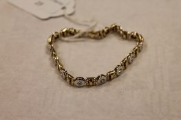 A 9ct two-tone gold bracelet, set with moissanite, 15.5g.  CONDITION REPORT: Good condition.