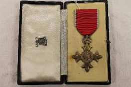 An O.B.E medal awarded to Charles R. Flynn, cased with award letter. CONDITION REPORT: Good