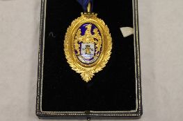 A 9ct gold and enamel Gentleman's medallion on blue ribbon, 41g, boxed. CONDITION REPORT: