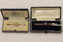 An Edwardian seed pearl bar brooch set with a diamond, together with a 9ct gold bar brooch. (2)