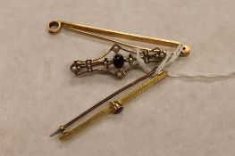 A 15ct gold bar brooch, together with a 9ct gold bar brooch and one other in yellow metal. (3)