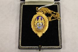 A 9ct gold and enamel Lady's medallion on chain, 21.3g, cased. CONDITION REPORT: The matching