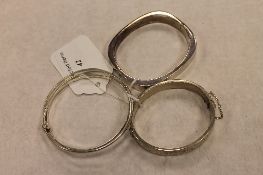 Two silver bangles, together with a sterling silver three-part bracelet. (3) CONDITION REPORT:
