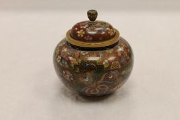 An early twentieth century fine cloisonne lidded pot, height 8.5 cm. CONDITION REPORT: Good