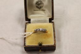 A five stone diamond ring mounted in yellow metal. CONDITION REPORT: The shank hallmarks rubbed.