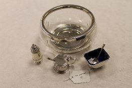 A silver mustard pot with liner and spoon, together with a silver salt, pepper pot, small silver