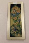 A Moorcroft tile, 9 cm x 29.5 cm, framed. CONDITION REPORT: Unexamined out of the frame, the reverse