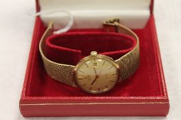 A 9ct gold Omega Gentleman's wrist watch, with original guarantee document, 64.2g, boxed.