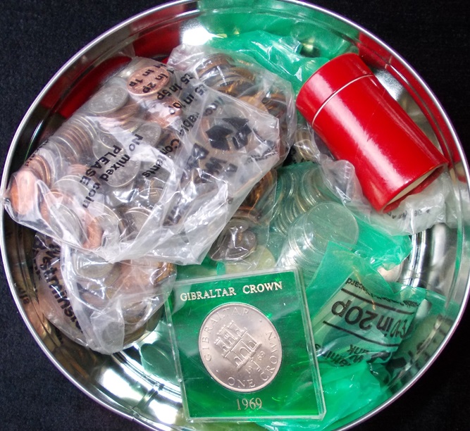 Tin of various foreign coins.