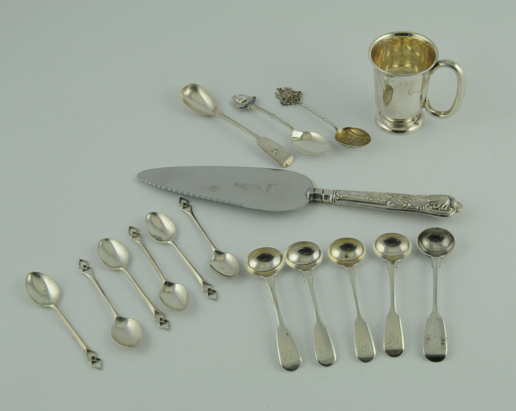 Small silver mug; six condiment spoons;